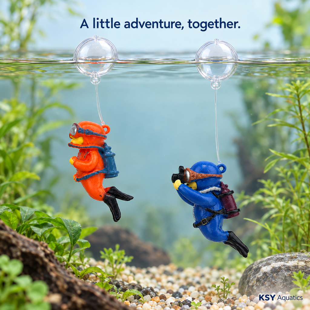 Orange and blue floating diver decorations displayed in an aquarium